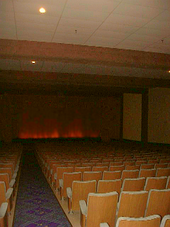 Interior of a 1950s-style fine arts movie theater auditorium. A low pitch viewing floor is used. 50sStyleMovieThearter.png