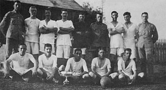 The football team of 95 Company, Royal Garrison Artillery, victors in the 1917 Governor's Cup football match, pose with the cup. The cup was contested annually by teams from the various Royal Navy, British Army Bermuda Garrison, and Royal Air Force units stationed in Bermuda. 95 Coy RGA team and Governor's Cup in Bermuda 1917.jpg