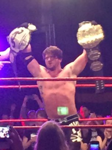 Styles has won numerous titles wrestling in international promotions, such as Revolution Pro Wrestling's RPW British Heavyweight Championship (right hand) and being a two-time IWGP Heavyweight Champion while with New Japan Pro-Wrestling (left hand). AJ Double Champion.png