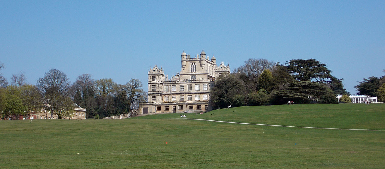 A view of Wollaton Hall west front, Stable Block and Camelia House from the south-west, Nottingham, England.jpg