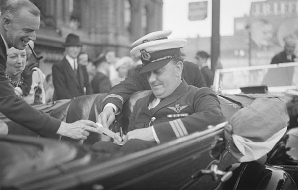 Captain Arthur Wilcockson, who was in charge of the notable flight of the flying boat Caledonia from Ireland to Canada, signs an autograph, 8 July 193