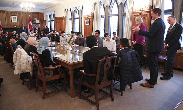 Kent (extreme right) meeting students during a school trip to Parliament Hill in 2018.