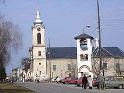 Street in Bajmok, the Catholic Church (right), and bell-tower of the Orthodox church (left)