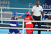 Deutsch: Boxen bei den Olympischen Jugendspielen 2018 Tag 12, 18. Oktober 2018 - Finale Fliegengewicht Mädchen – Martina La Piana (Italien, blau) schlägt Adijat Gbadamosi (Nigeria, rot) 5-0; Ringrichter ist James Beckles (Trinidad und Tobago). English: Boxing at the 2018 Summer Youth Olympics on 18 October 2018 – Girl's flyweight Gold Medal Bout - Martina La Piana (Italy, blue) beats Adijat Gbadamosi (Nigeria, red) 5-0; Referee is James Beckles (Trinidad and Tobago). Español: Boxeo en los Juegos Olímpicos Juveniles de Verano de 2018 en 18 de octubre de 2018 - Combate a medalla de oro de peso mosca para mujeres: Martina La Piana (Italia, azul) le gana a Adijat Gbadamosi (Nigeria, roja) 5-0; El árbitro es James Beckles (Trinidad y Tobago).