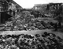 Bodies of inmates of the Mittelbau-Dora Nazi concentration camp who died during Allied bombing raids on April 3 and 4, 1945 Rows of bodies of dead inmates fill the yard of Lager Nordhausen, a Gestapo concentration camp.jpg