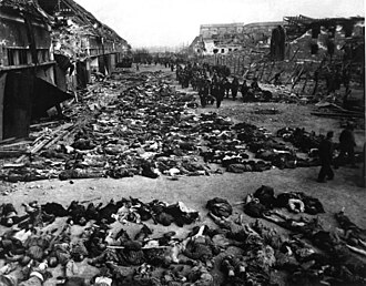 Bodies of inmates of the Mittelbau-Dora Nazi concentration camp who died during Allied bombing raids on April 3 and 4, 1945 Rows of bodies of dead inmates fill the yard of Lager Nordhausen, a Gestapo concentration camp.jpg