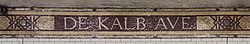 A tile mosaic at the station, with the name "De Kalb Ave" in capital letters.
