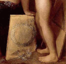 A detail from Dosso Dossi's Allegory of Music with an anonymous canon notated in a circle and a canon by Josquin notated in a triangle. (The notes of the triangular canon can be seen on the original painting under raking light.) Dosi allegory canon.png