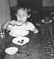A young Ekcharin Norodom eating rice with a spoon, December 1973