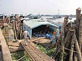 Transport boats moored at fish processing plant. My Tho, Mekong delta, Vietnam.