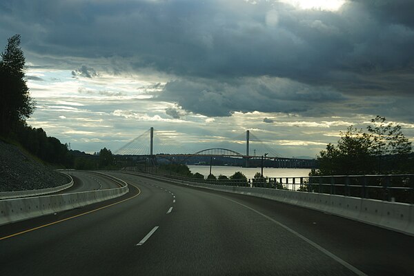 Highway 17 looking South near Port Mann (Surrey) British Columbia. New and old Port Mann Bridge in background.