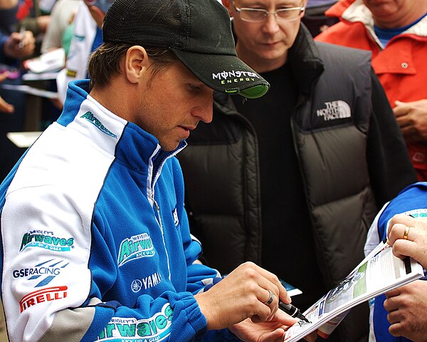 Ellison signing autographs during the 2009 BSB championship at Snetterton