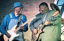 Christone "Kingfish" Ingram (right) performing with Buddy Guy, 2018 Kingfish Ingram BuddyGuy.jpg