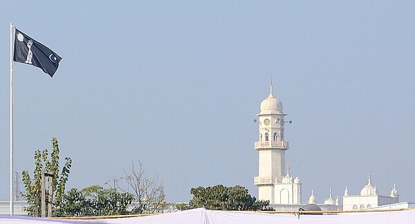 The White Minaret and the Ahmadiyya flag in Qadian, India. For Ahmadi Muslims, the two symbolize the advent of the Mirza Ghulam Ahmad.