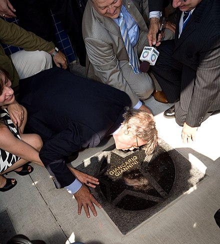 Giancarlo Giannini placing his handprint on his star at the Italian Walk of Fame