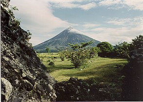 Mayon Volcano overlooks a pastoral scene approximately five months before the volcano's violent eruption in September 1984.