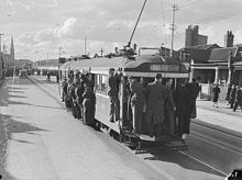 A W2-class tram overloaded with passengers on Brunswick Street, Fitzroy North in 1944 Melbourne tram surf.jpg