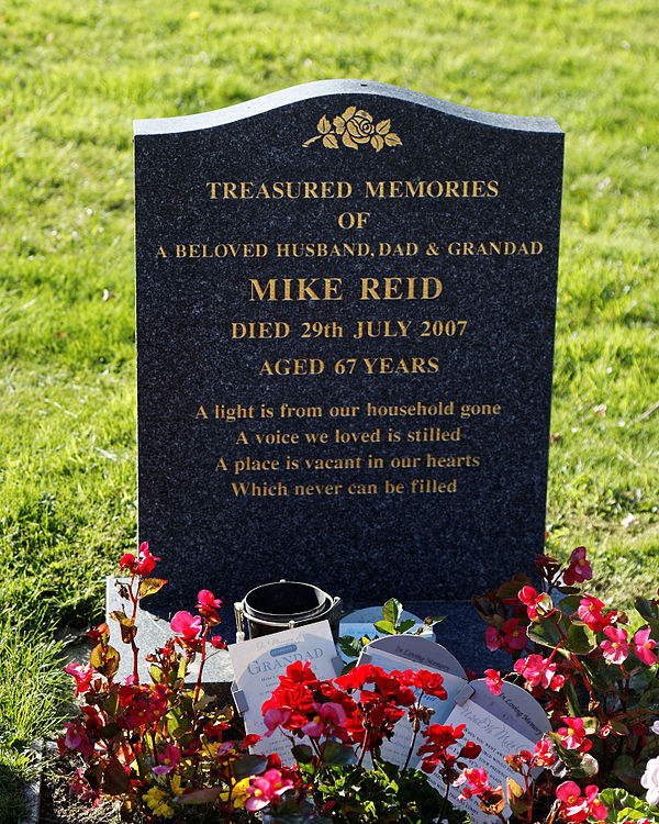 Mike Reid's gravestone in the graveyard of St Mary's Church, Little Easton, Essex