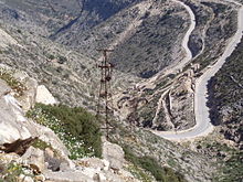 photographie : paysage sec de montagne avec un pylône rouillé
