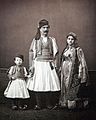 (1. centre) rich Albanian man from Janina; (2. right) rich Albanian woman from Janina; (3. left) child of a Albanian rich family (source: Les Costumes populaires de la Turquie en 1873, Constantinople 1873, plate 18) Photo published by Robert Elsie at albanianphotography.net