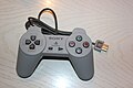 The. PlayStation Classic controller by itself.