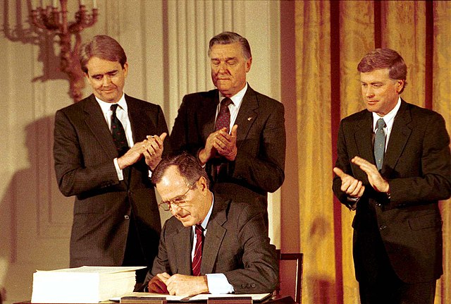 President George H. W. Bush signs the Clean Air Act Amendments of 1990 at the White House, November 15, 1990.