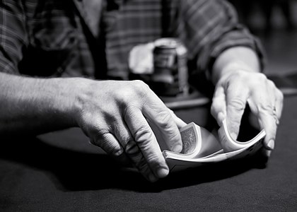 A riffle shuffle being performed during a game of poker