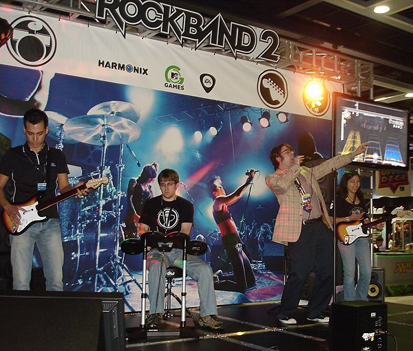 Players performing at a PAX event while playing Rock Band 2