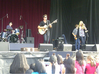 Mendler performing with her then-boyfriend, Shane Harper, in 2011 Shane Harper PNE 032.png