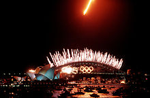 An Australian F-111 overflies the Sydney Harbour Bridge performing the dump-and-burn to mark the conclusion of the 2000 Summer Olympics.