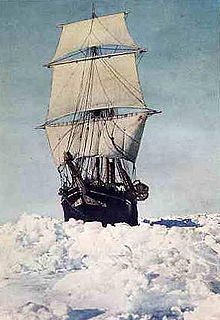 Frontal view of ship with sails all set, moving through thick sea ice