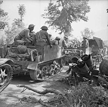 Universal Carriers of the 1st Battalion, Royal Irish Fusiliers pass a wrecked German Nebelwerfer rocket launcher near Ceprano, Italy, 28 May 1944. The British Army in Italy 1944 NA15654.jpg