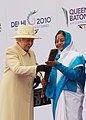 The Queen passing the Baton to President Patil of India for the Baton relay for the Delhi Commonwealth Games, 2009