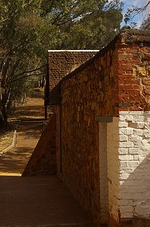 Side of the complex with broken glass embedded into the top of the wall to discourage escape attempts Toodyay gaol gnangarra 02.jpg