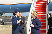 Hillary Clinton holding a BlackBerry phone in 2009 U.S. Air Force Col. Peggy Poore, commander, 65th Air Base Wing, greets Secretary of State Hillary Rodham Clinton during a stop at Lajes Field, Azores, Portugal, June 3, 2009 090603-F-MK264-040.jpg