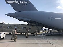 US airmen evacuating their final CH-47 Chinook onto a C-17 Globemaster III at Kabul Airport in August 2021. U.S. Airmen load the final Boeing CH-47 Chinook in Afghanistan onto a Boeing C-17 Globemaster III.jpg