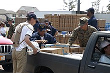 Dutch sailors, U.S. Marines, and U.S. Navy sailors unloading aid supplies in Mississippi. US Navy 050908-N-8154G-051 U.S. Navy Sailors assigned to the amphibious assault ship USS Bataan (LHD 5), Dutch Sailors from frigate Van Amstel (F 831) and U.S. Marines load cases of bottled water and Meals Ready-to-Eat (MRE).jpg