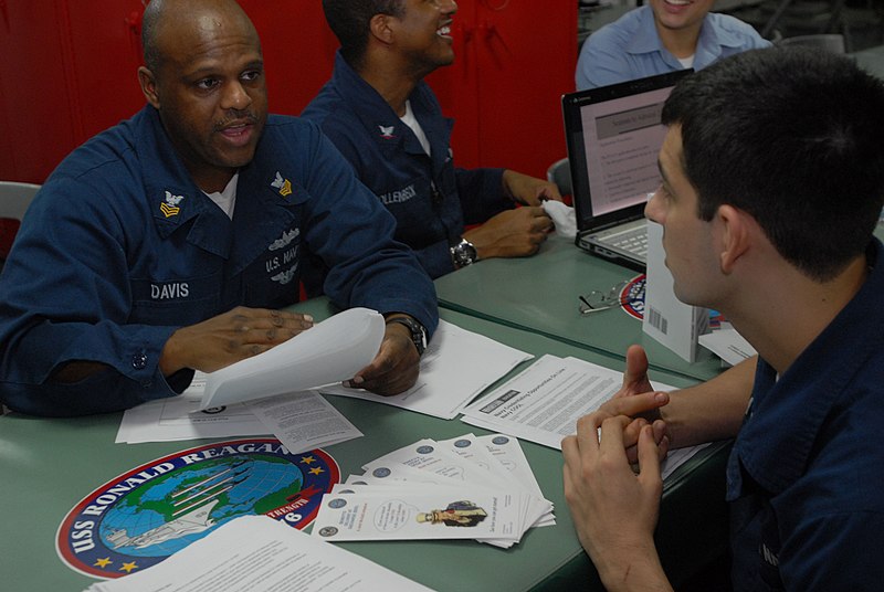 File:US Navy 090822-N-5749W-134 Personnel Specialist 1st Class Charles Davis councils an undesignated Sailor on possible career opportunities during a career fair aboard the aircraft carrier USS Ronald Reagan (CVN 76).jpg