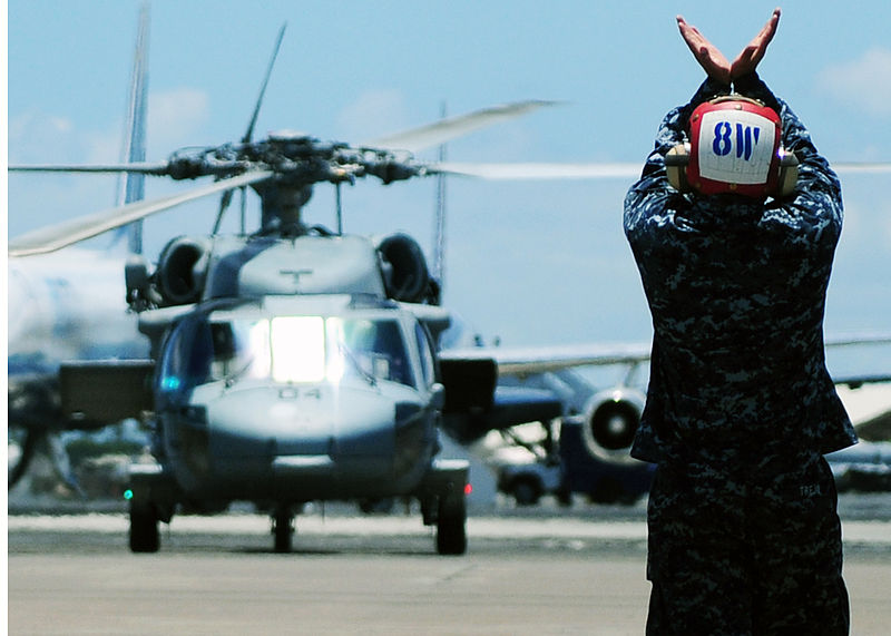 File:US Navy 100720-N-6854D-049 Aviation Ordnanceman Airman Mario Trejo signals the pilot of an MH-60S Sea Hawk helicopter.jpg