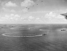 Task Group 58.1 reversing course during the attack on Yap, 28 July 1944. Hornet is in the center, with the light carrier Cabot in the left middle distance and Yorktown at right. Seven Hellcats are overhead. US Navy Task Group 58.1 underway in July 1944.jpg