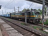 Wag-9 Locomotive at Vangaon Railway station, pulling an automobile carrier rake.