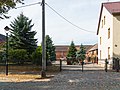 Three side buildings, barn, pigeon house and pavement of a three-sided courtyard