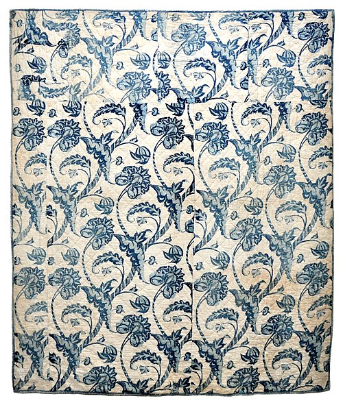 This early American wholecloth quilt was made in the Colonial period, c. 1760–1800. The blue resist fabric includes bold, fanciful botanical motifs. C