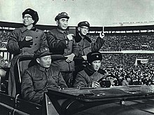 Jiang Qing (left), who was the wife of Mao Zedong and a member of the Gang of Four, received the Red Guards in Beijing with Premier Zhou Enlai (center) and Kang Sheng. They were all holding the Little Red Book (Quotations from Mao) in their hands. 1967-03 1966Nian 12Yue 26Ri Jiang Qing Zhou En Lai Kang Sheng Jie Jian Hong Wei Bing .jpg