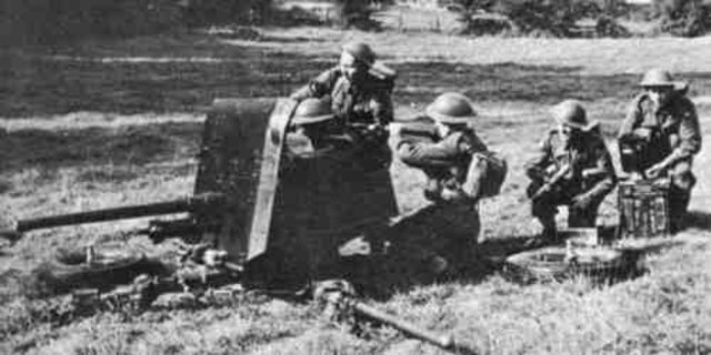 2 pounder in action with British troops. Legs are unfolded.