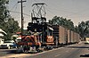 Sacramento Northern Railway locomotive 654 pulls a freight train on street trackage in Yuba City in August 1964