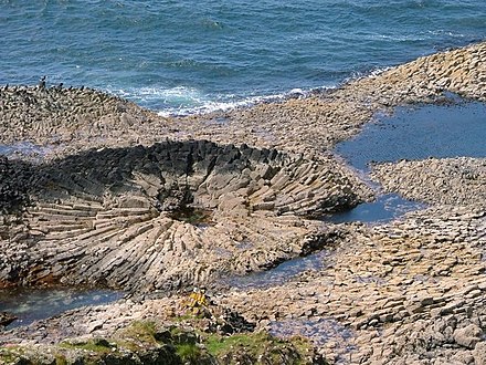 On a Mull beach basalt columns radiate away from the location of a tree trunk consumed by a Palaeocene lava eruption.