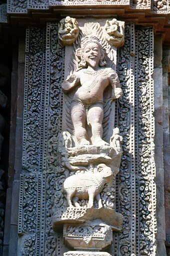Agni god in southeast corner of the 11th-century Rajarani Temple in Bhubaneshwar Odisha. The ram is carved below him.