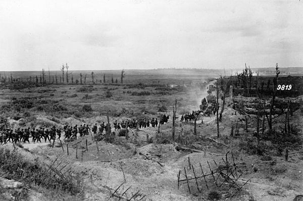 "German soldiers advancing past a captured French position, between Loivre and Brimont, Marne department, 1918"[attribution needed]