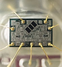 The optical chip extracted from a CD player. The three dark rectangles are photosensitive, read the data from the disk and keep the beam focused. Electronic tracking, aided with the two photodiodes at the sides, keeps the laser beam centered on the middle of the data track. CD Player Photodetector Chip.jpg